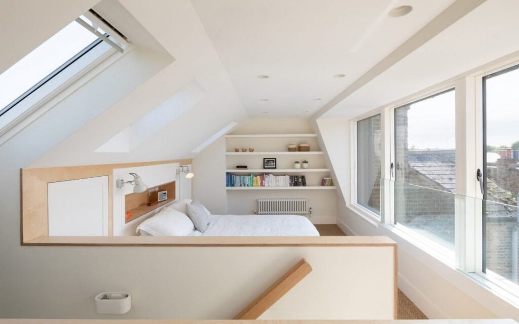 Light and airy loft space with wooden floor and skylights.