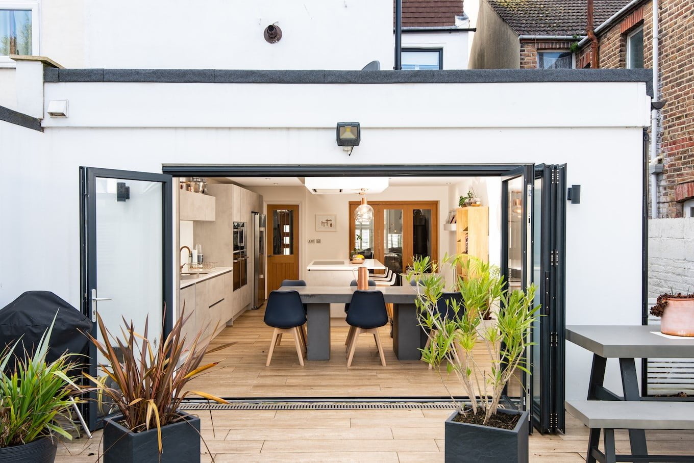 An image of a house extension with bi-fold doors in Sussex