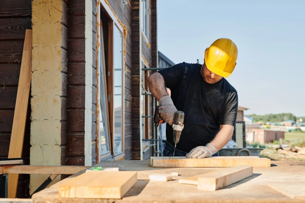 Image of a builder installing locally sourced materials in a new construction project