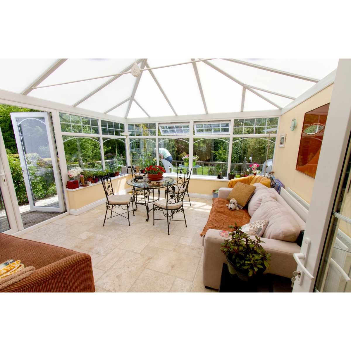 A beautifully renovated conservatory featuring modern design elements, a comfortable seating area, and an abundance of natural light, exemplifying a perfect sunlit sanctuary.