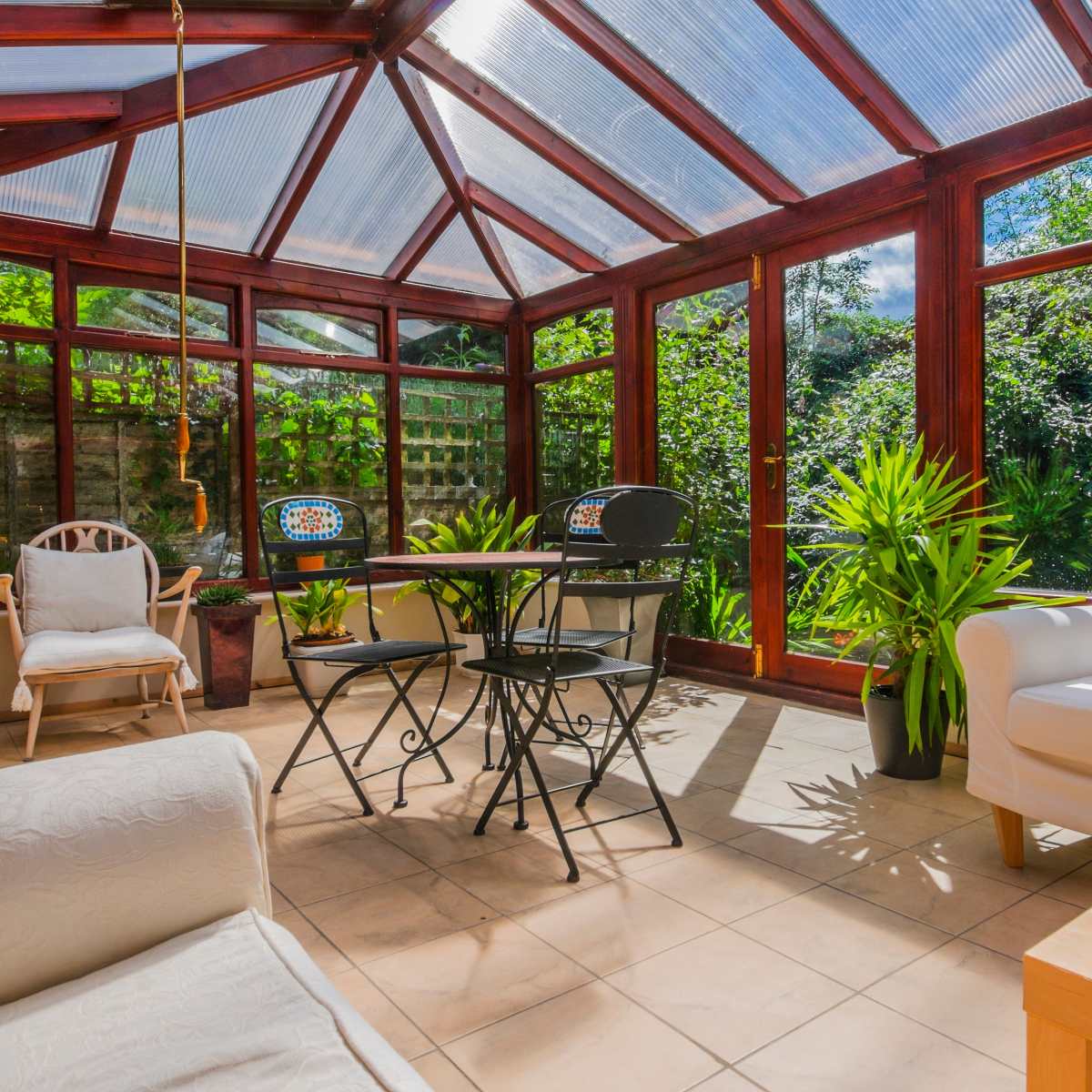 A beautifully renovated conservatory showcasing modern design elements, improved energy efficiency and stylish furnishings.