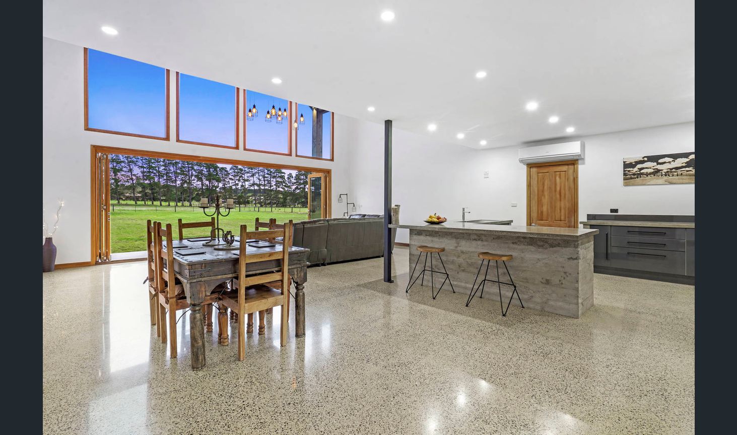 A picturesque representation of a home integrating indoor and outdoor spaces seamlessly, highlighting the beauty of nature-infused architectural design.