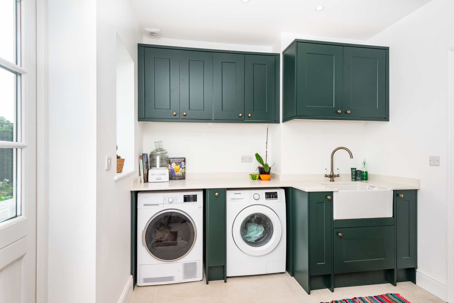 Interior view of a newly renovated utility room with modern appliances and efficient storage.