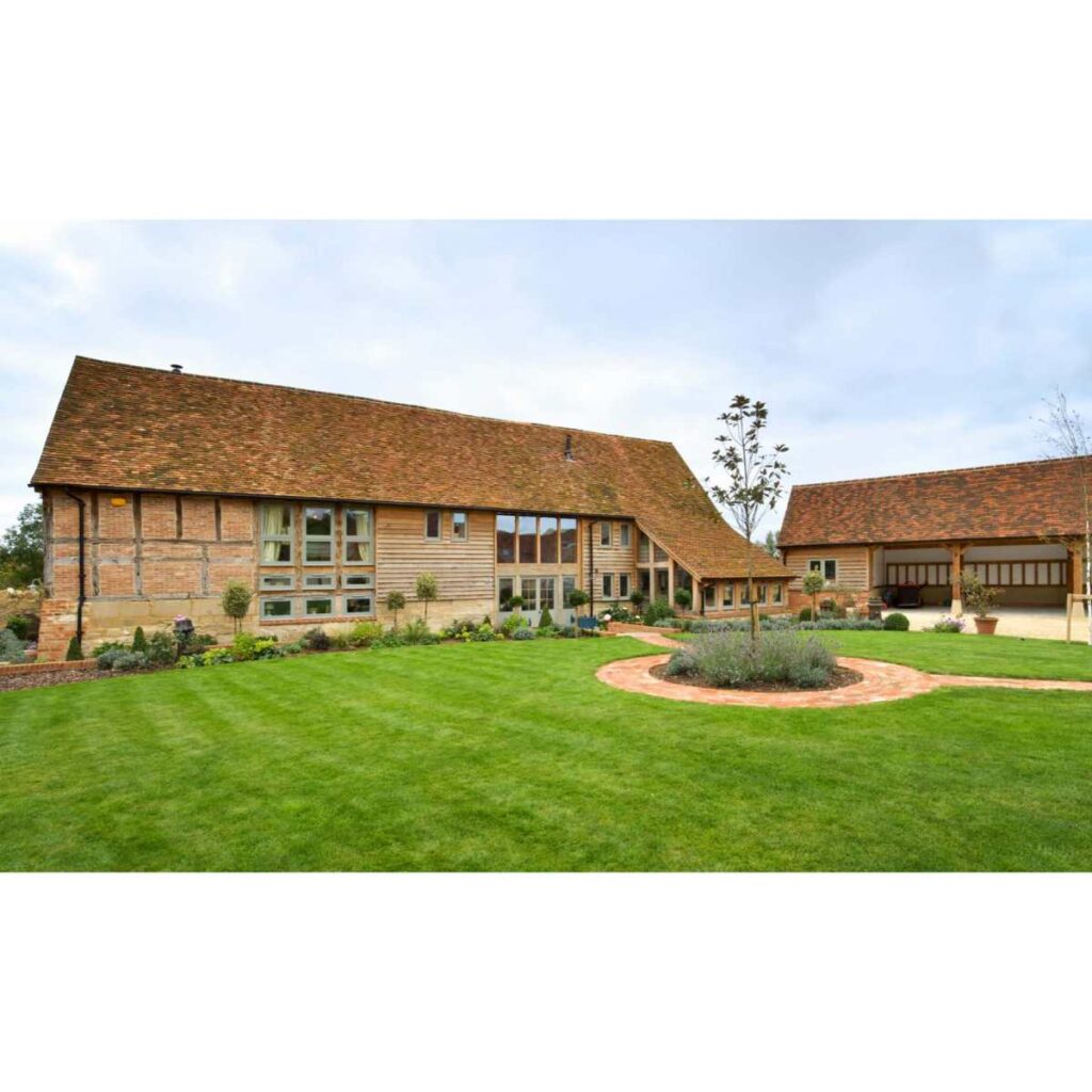 Exterior of a beautifully designed barn conversion with a blend of traditional and modern architectural elements.