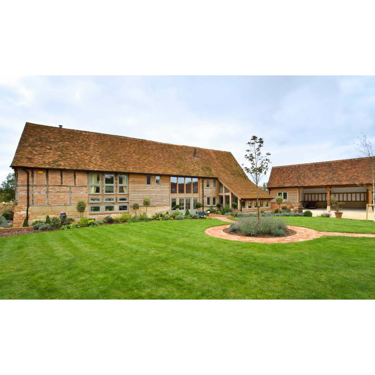 Exterior of a beautifully designed barn conversion with a blend of traditional and modern architectural elements.